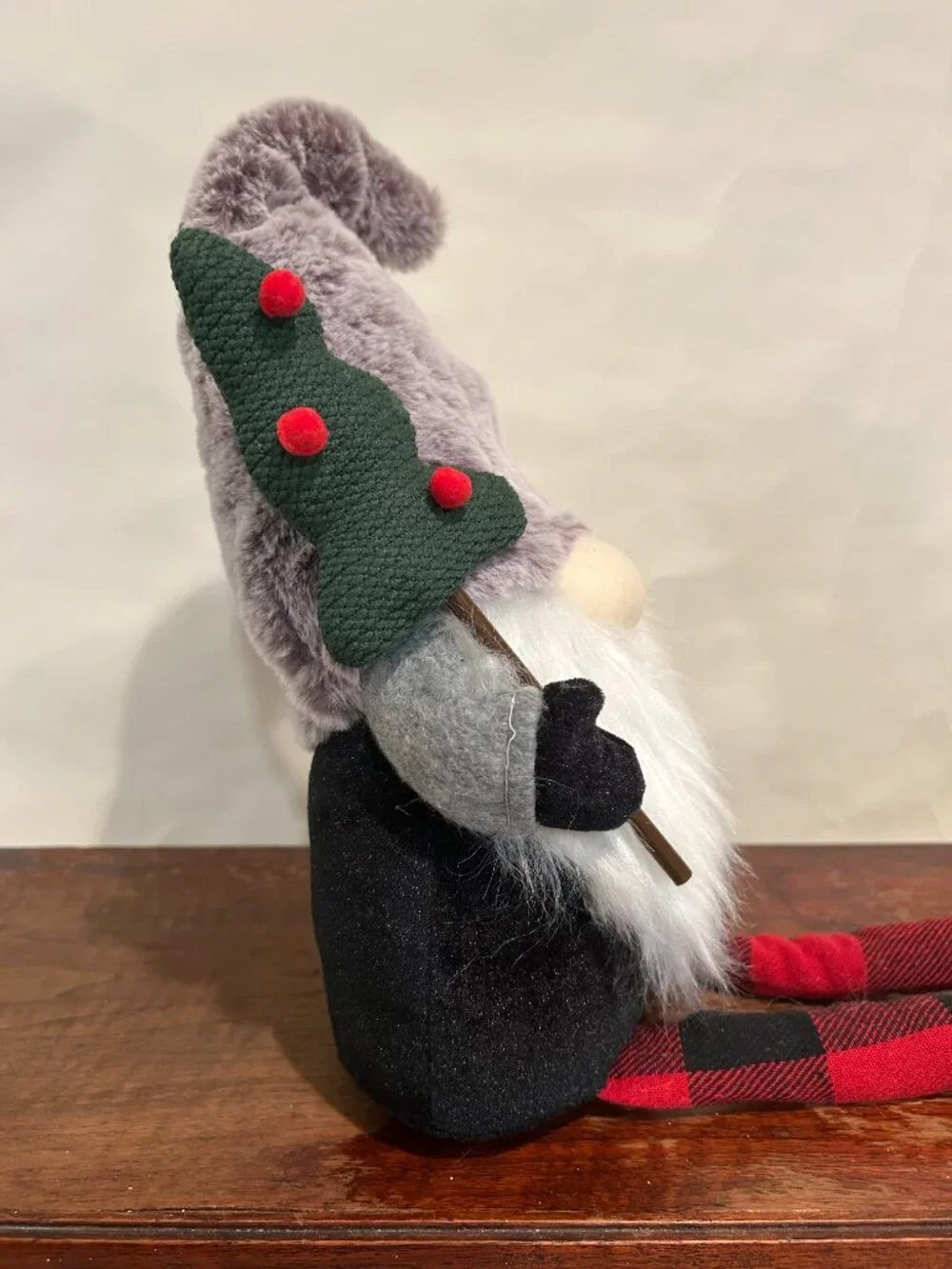 Christmas Holiday Gnome with gray cap and wispy white beard, holding tree